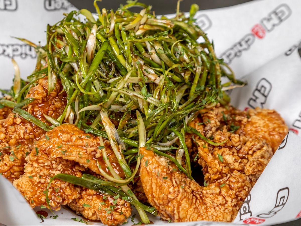 Glazed boneless fried chicken topped with a tall nest of shredded green onion