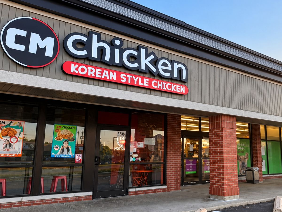 Storefront at 2236 E 62nd St with the round CM logo and red Korean Style Chicken sign at sunset
